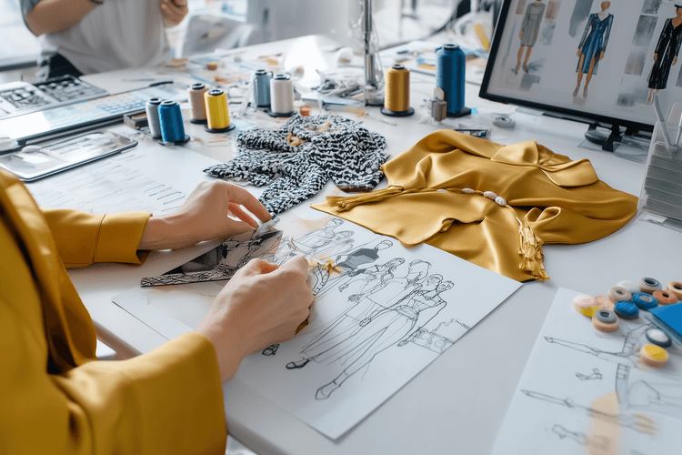 Fashion designer sketching at desk